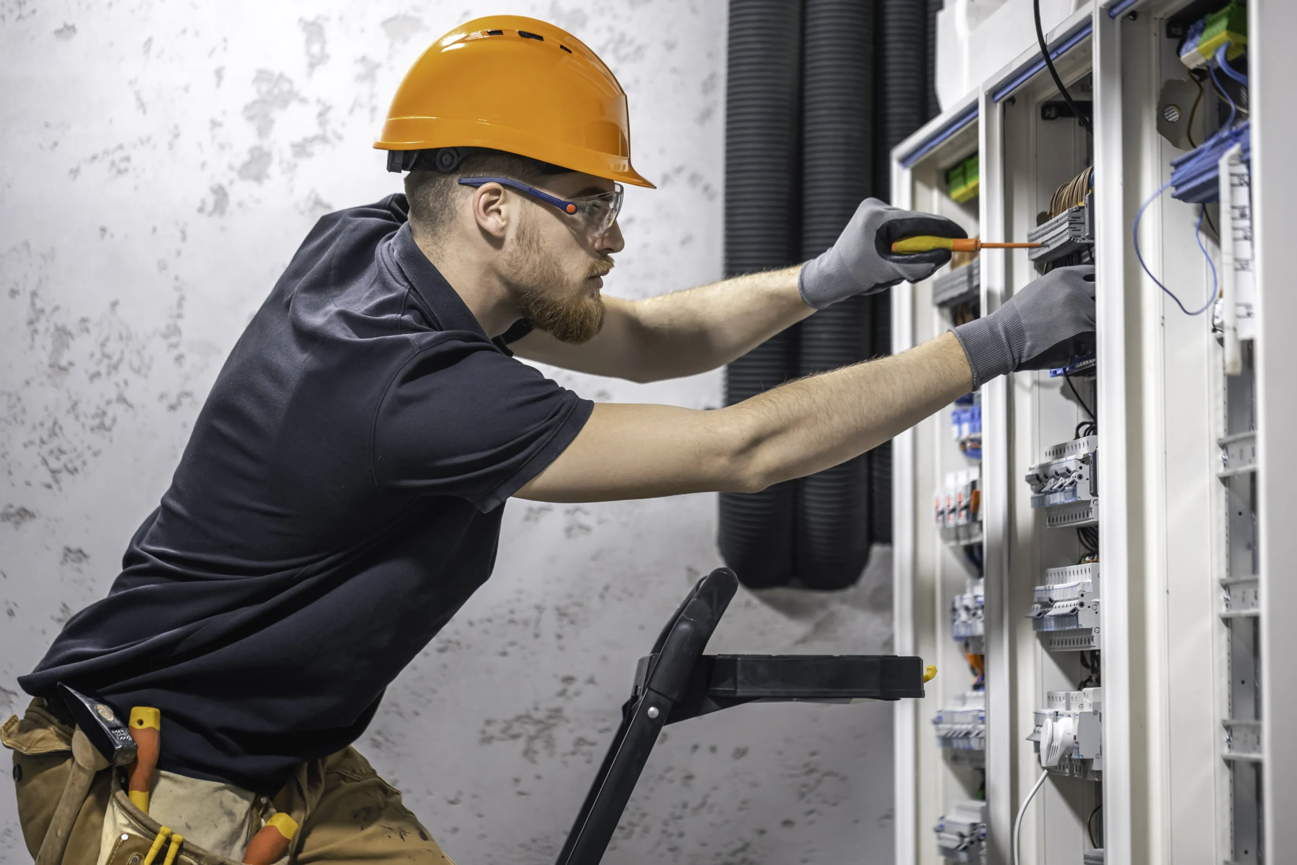 Hotel maintenance worker repairing guest room equipment — Team Plus Hotel Staffing Solutions Miami South Florida