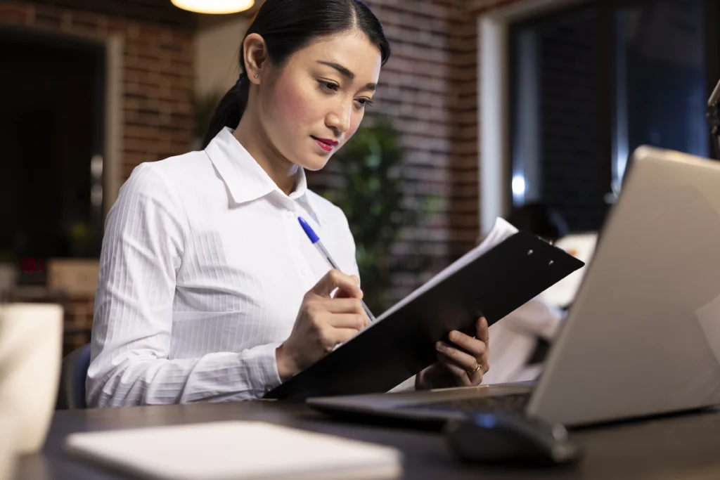 Staffing recruiter reviewing hotel candidate profiles — Team Plus Hotel Staffing Solutions South Florida